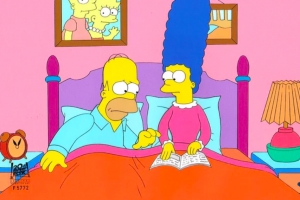 Homer Simpson and Marge Simpson in bed with photo of kids